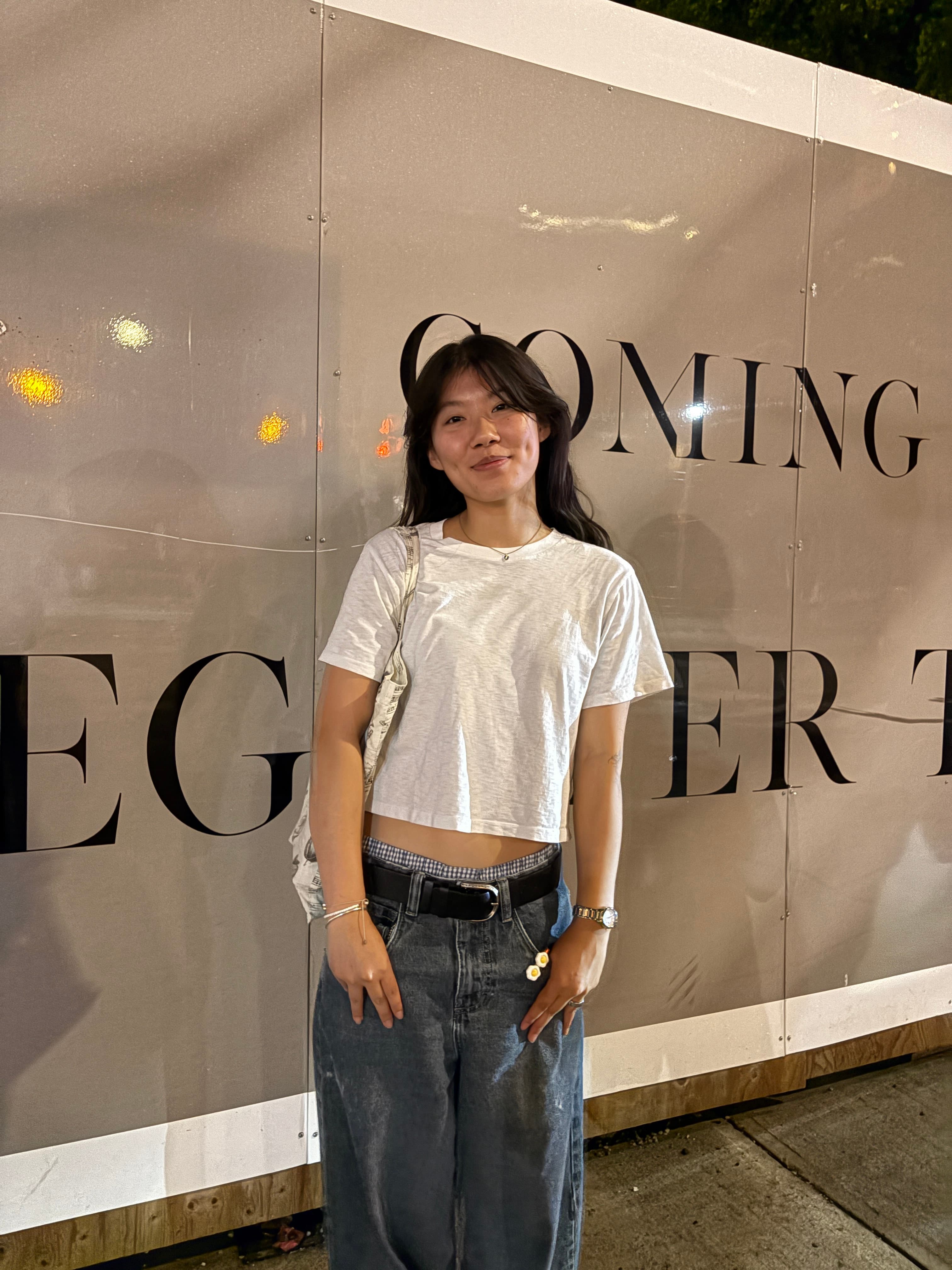 Hanjing Lin standing in front of an outdoor wall